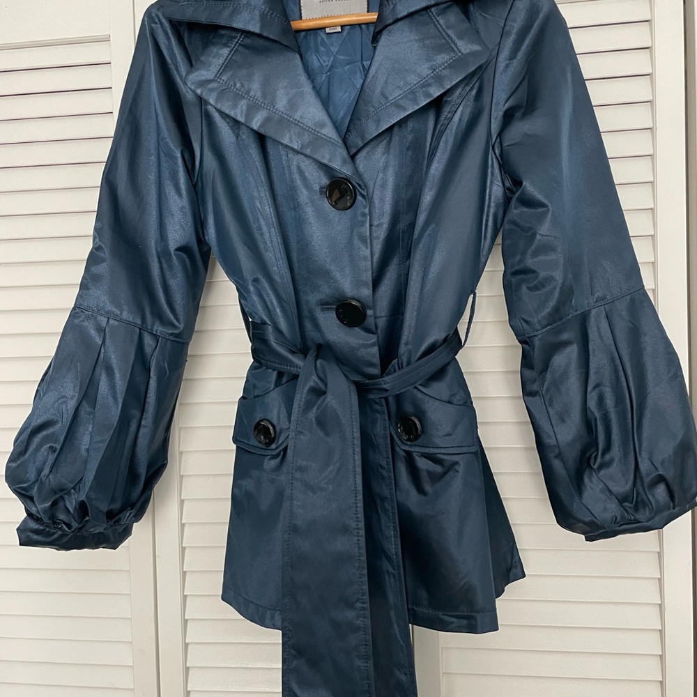 Women’s trench coat with quilted liner; side pockets and stylish belt to match.